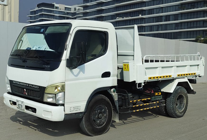 BHMK white Mitsubishi Fuso Canter tipper truck for sand and material delivery in Dubai