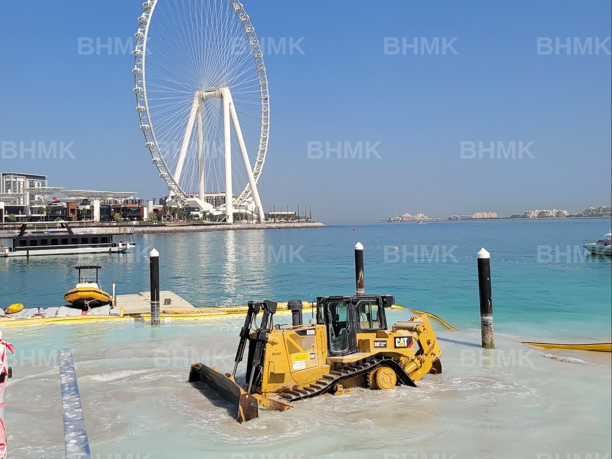 BHMK CAT D8R dozer working in the water during beach nourishment at Bluewaters, Dubai