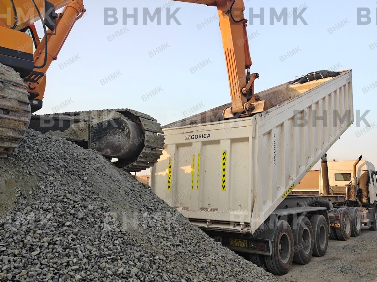 Komatsu excavator loading a Volvo articulated dump truck