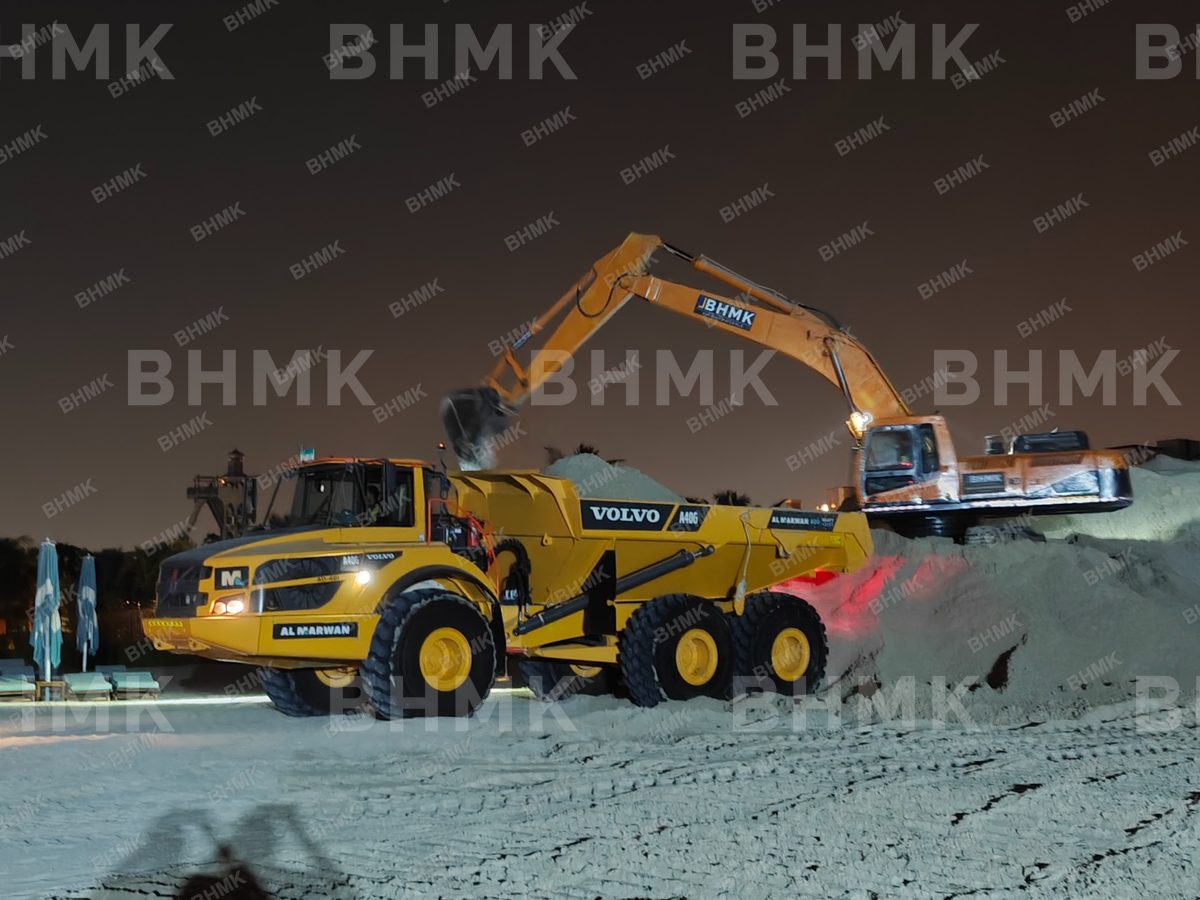 Excavator loading aggregate into a tipper trailer