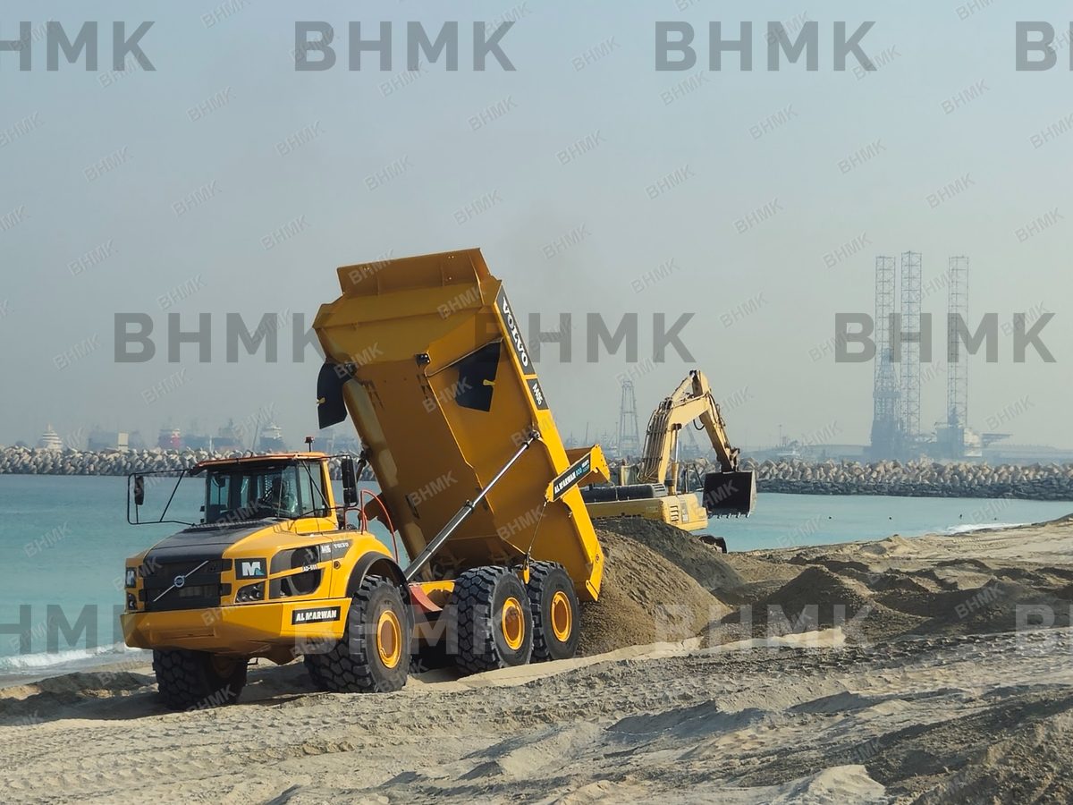 Dump truck tipping sand for shore protection works